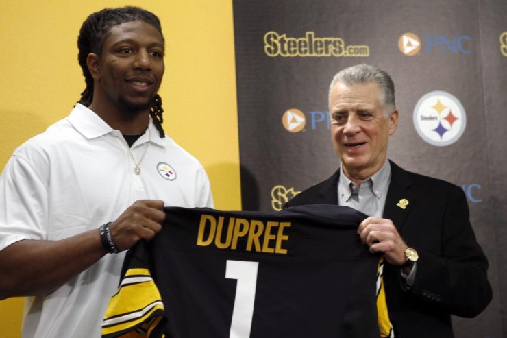Alvin "Bud" Dupree, a linebacker out of Kentucky, left, poses with a team jersey beside Pittsburgh Steelers President Art Rooney II as he is introduced at a news conference, Friday, May 1, 2015, in Pittsburgh, Depree was chosen by the Pittsburgh Steelers in the first round, 22nd overall, in the NFL football draft on Thursday. (AP Photo/Keith Srakocic)